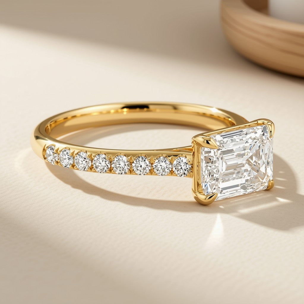Emerald-cut diamond pavé ring in 14K yellow gold, side view