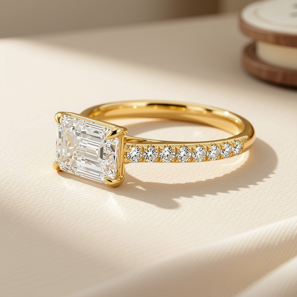 Emerald-cut diamond pavé ring in 14K yellow gold, angled view