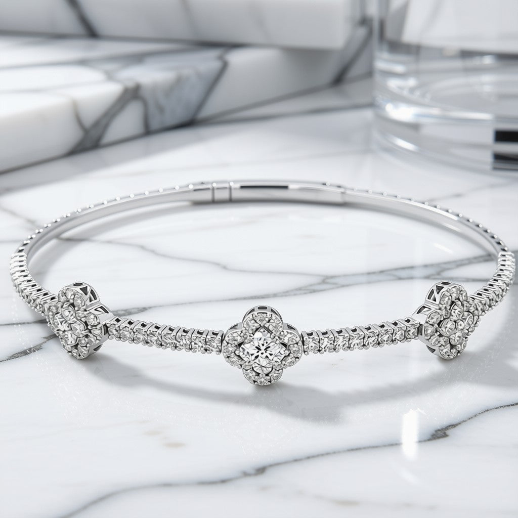 Diamond Clover Station Bangle Bracelet in 14K White Gold on marble surface