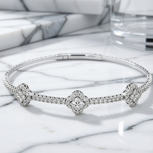 Diamond Clover Station Bangle Bracelet in 14K White Gold on marble surface